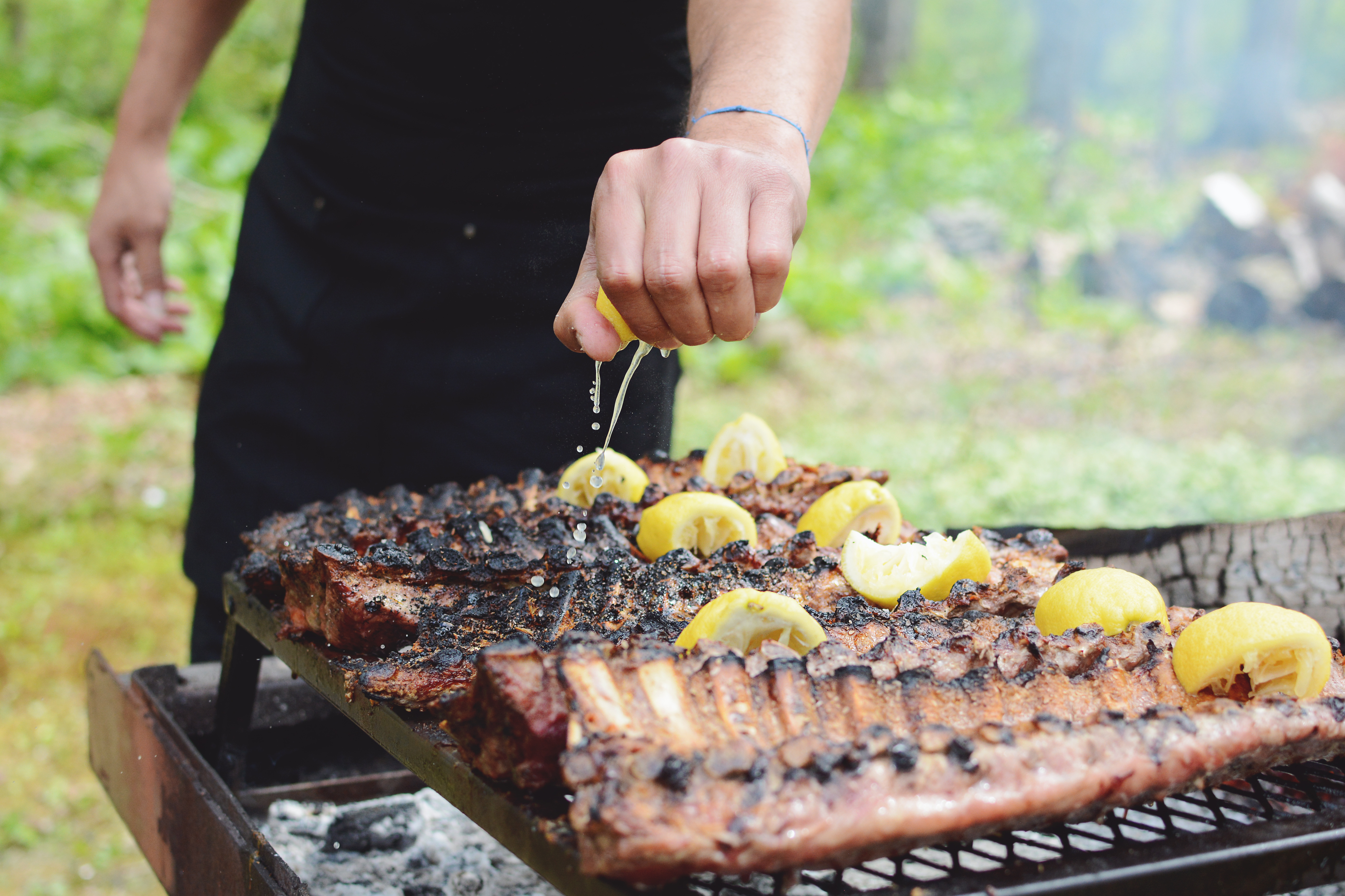 Grilling meat over open fire